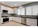 Updated kitchen with stainless steel appliances and contrasting dark countertops at 4835 Willow Glen Dr, Las Vegas, NV 89147