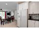 Bright kitchen with a white refrigerator and ample cabinet space, adjacent to the dining area at 4835 Willow Glen Dr, Las Vegas, NV 89147