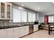 Modern kitchen featuring white cabinets, black countertops, and stainless steel appliances at 4835 Willow Glen Dr, Las Vegas, NV 89147