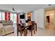 Spacious living room with a fireplace, TV, and an adjacent dining area, perfect for entertaining at 4835 Willow Glen Dr, Las Vegas, NV 89147