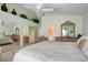Bright main bedroom with neutral color palette, vaulted ceiling, and dual mirrored closets at 4835 Willow Glen Dr, Las Vegas, NV 89147