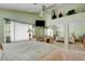 Spacious main bedroom featuring comfortable seating area, large window and mirrored closets at 4835 Willow Glen Dr, Las Vegas, NV 89147