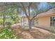 Inviting backyard with mature trees offering shade over a covered patio and landscape at 5529 Cranwood Ct, Las Vegas, NV 89130