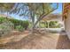 Peaceful backyard with mature landscaping and a covered patio, perfect for relaxing at 5529 Cranwood Ct, Las Vegas, NV 89130