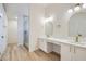 Stylish bathroom featuring double sinks, elegant mirrors, and a glass-enclosed shower at 5529 Cranwood Ct, Las Vegas, NV 89130