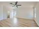 Spacious bedroom featuring wood-look flooring, a ceiling fan, and ample natural light at 5529 Cranwood Ct, Las Vegas, NV 89130