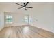 Bright bedroom with wood-look floors, natural light, and a ceiling fan at 5529 Cranwood Ct, Las Vegas, NV 89130
