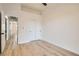 Neutral bedroom with wood-look floors featuring a closet and access to other rooms at 5529 Cranwood Ct, Las Vegas, NV 89130