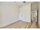 Bedroom features neutral walls, light wood-look floors, and access to adjacent rooms at 5529 Cranwood Ct, Las Vegas, NV 89130