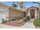 Charming single-story home with a red front door, well-maintained landscaping, and a two-car garage at 5529 Cranwood Ct, Las Vegas, NV 89130