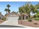 Charming single-story home featuring a well-maintained front yard with mature trees and a two-car garage at 5529 Cranwood Ct, Las Vegas, NV 89130