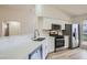 Bright kitchen with white cabinets, stainless appliances, and white counter tops at 5529 Cranwood Ct, Las Vegas, NV 89130