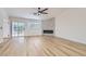 Bright living room boasting a modern fireplace, ceiling fan, wood-look floors, and natural light at 5529 Cranwood Ct, Las Vegas, NV 89130