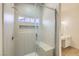Modern shower featuring tiled walls, a built-in bench, and glass door at 5529 Cranwood Ct, Las Vegas, NV 89130