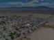 This aerial shot displays a neatly arranged residential area set against a stark desert landscape, with mountain views at 565 Mazelle Ln, Pahrump, NV 89060