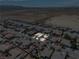 Expansive aerial view of a well-maintained neighborhood in a desert climate, showcasing community layout and surrounding landscape at 565 Mazelle Ln, Pahrump, NV 89060