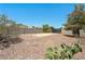 Large gravel backyard with potential RV parking, secured by a metal gate at 565 Mazelle Ln, Pahrump, NV 89060