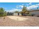 Large gravel backyard with potential RV parking, secured by a metal gate at 565 Mazelle Ln, Pahrump, NV 89060