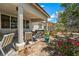 Charming covered patio area with cozy seating and landscaped yard at 565 Mazelle Ln, Pahrump, NV 89060