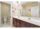 Bathroom featuring double sinks and a large mirror at 565 Mazelle Ln, Pahrump, NV 89060