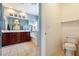 Bathroom featuring dual sinks, dark wood cabinets, shower and a bath at 565 Mazelle Ln, Pahrump, NV 89060