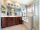 Bathroom featuring dual sinks, dark wood cabinets, shower and a bath at 565 Mazelle Ln, Pahrump, NV 89060