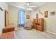 Well-lit bedroom featuring a chair, cabinets and a ceiling fan at 565 Mazelle Ln, Pahrump, NV 89060