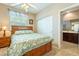 This naturally-lit bedroom features a ceiling fan and attached bathroom at 565 Mazelle Ln, Pahrump, NV 89060
