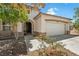 Charming two-story home with a manicured front yard and attached garage at 565 Mazelle Ln, Pahrump, NV 89060