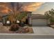 Charming single-story home features manicured landscaping and a spacious two-car garage at 565 Mazelle Ln, Pahrump, NV 89060