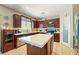 Open kitchen featuring a large island, stainless steel appliances, and dark wood cabinets at 565 Mazelle Ln, Pahrump, NV 89060