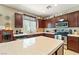 Kitchen featuring stainless steel appliances, center island, and dark wood cabinets at 565 Mazelle Ln, Pahrump, NV 89060