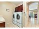 This laundry room features tile floors, a washer and dryer and bright lighting at 565 Mazelle Ln, Pahrump, NV 89060