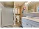 Bathroom showcasing white vanity, shower, and toilet with cute decor at 5831 Medallion Dr # 103, Las Vegas, NV 89122