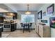 The dining area features a round table with bar seating, stylish lighting, and decor for an inviting dining experience at 5831 Medallion Dr # 103, Las Vegas, NV 89122