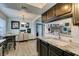 Spacious kitchen with granite countertops, stainless sink, and open view to adjacent rooms at 5831 Medallion Dr # 103, Las Vegas, NV 89122