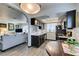 The kitchen connects to the living room and has stainless steel appliances, granite counters, and dark cabinets at 5831 Medallion Dr # 103, Las Vegas, NV 89122