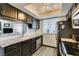 Updated kitchen features stainless steel appliances, granite countertops, and dark cabinetry at 5831 Medallion Dr # 103, Las Vegas, NV 89122