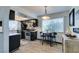 Well lit kitchen with dark cabinets, stainless steel appliances, and a charming breakfast nook near the window at 5831 Medallion Dr # 103, Las Vegas, NV 89122