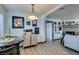 Open floor plan seamlessly blends dining area with living room featuring a stylish fireplace and comfortable sofa at 5831 Medallion Dr # 103, Las Vegas, NV 89122