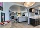 Bright and open layout connecting the kitchen and living room with a gray sofa, perfect for modern living at 5831 Medallion Dr # 103, Las Vegas, NV 89122