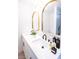 Bright bathroom with dual sinks, white cabinets, quartz countertop, modern mirrors, and black faucets at 6170 W University Ave, Las Vegas, NV 89103