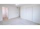 Minimalist bedroom with white walls, carpet, a ceiling fan, and large sliding door closet at 6170 W University Ave, Las Vegas, NV 89103