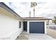Charming single-story home featuring a dark garage door, solar panels, and a well-maintained front yard at 6170 W University Ave, Las Vegas, NV 89103