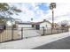 Charming single-story home with a secure gated fence and desert landscaping at 6170 W University Ave, Las Vegas, NV 89103