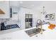 Bright kitchen featuring white cabinets, stainless appliances, quartz countertop, and a dining area at 6170 W University Ave, Las Vegas, NV 89103