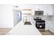 Modern kitchen featuring stainless steel appliances, white cabinets, quartz countertops, and an island at 6170 W University Ave, Las Vegas, NV 89103