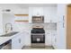 Modern kitchen featuring white cabinets, stainless steel appliances, and stylish finishes at 6170 W University Ave, Las Vegas, NV 89103