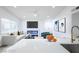 Open-concept living area with a modern kitchen, fireplace, and large windows at 6170 W University Ave, Las Vegas, NV 89103
