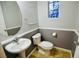 Charming powder room featuring a stylish sink, decorative mirror, and unique stained-glass window at 6545 Netherseal Ave, Las Vegas, NV 89139